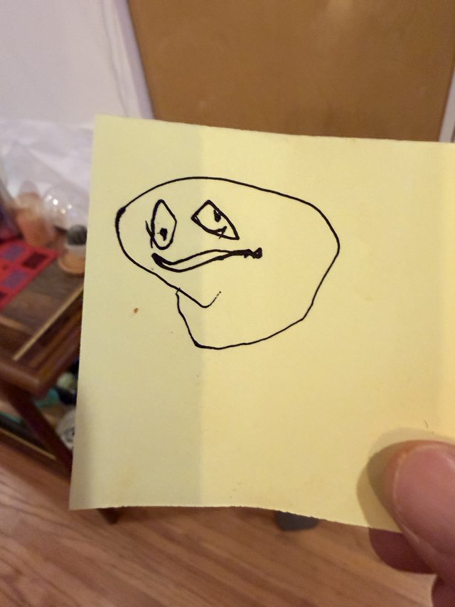 Hand-Drawn Meme Face on Yellow Sticky Note