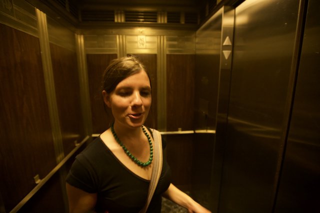 Woman in Vintage Elevator During Art Walk
