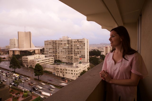 Woman Gazes Over San Francisco Cityscape at Dusk