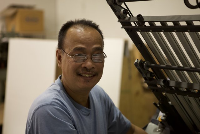Smiling Man at the Printing Machine