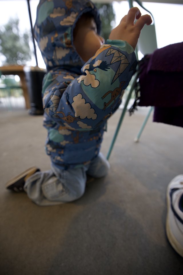 Toddler in Dinosaur Pajamas at Restaurant
