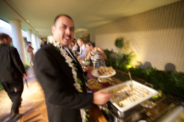 Tuxedoed server at a wedding buffet