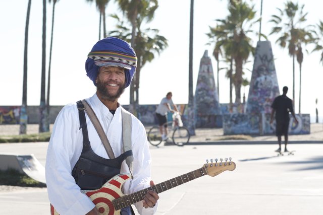 Turbaned Guitarist Under The Palm Tree