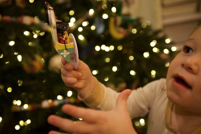 Child's Joyful Wonder at Christmas Tree Ornament