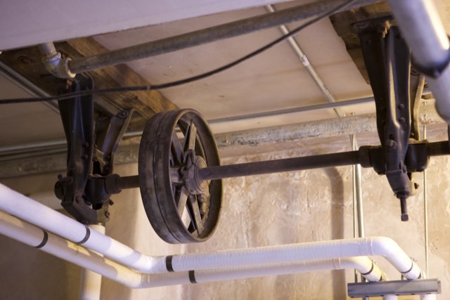 Wheel and Pipe Hanging from Ceiling