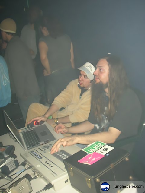 Long-Haired Man Working on Laptop at the Club