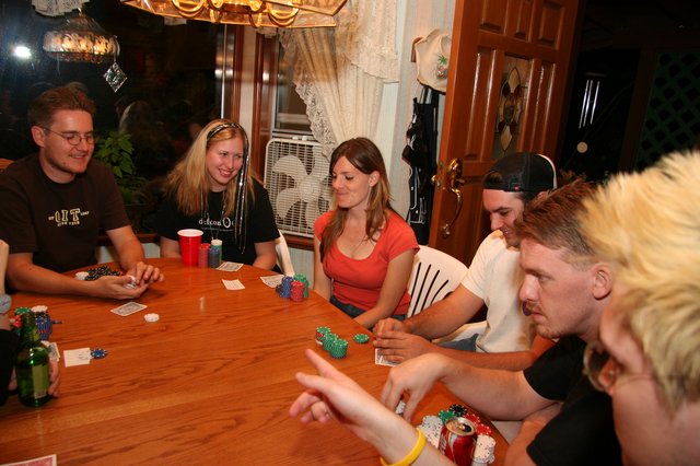 Friends Gathered Around Table for Poker Night