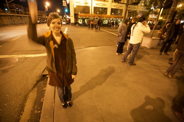 Woman on City Street During Evening Celebration