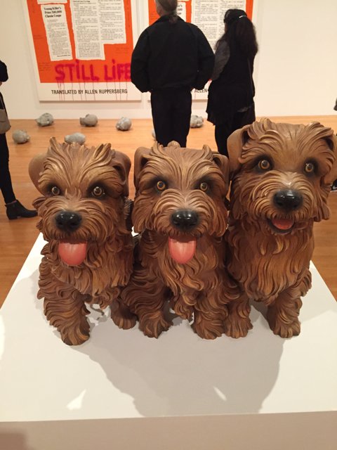 Three Terrier Statues Adorn a Wooden Table