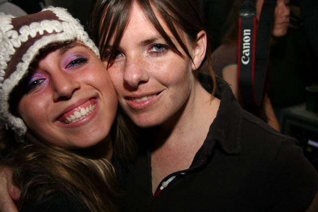 Two Friends Smiling Together at a Night Event