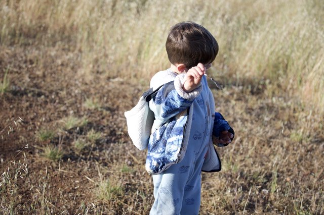 Young Explorer Ventures Through Dry Grassland Field