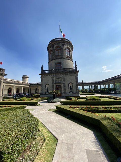 Flag and Garden Beneath Towering Architecture
