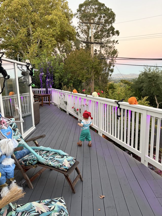 Child Explores Decorated Deck During Smoky Conditions