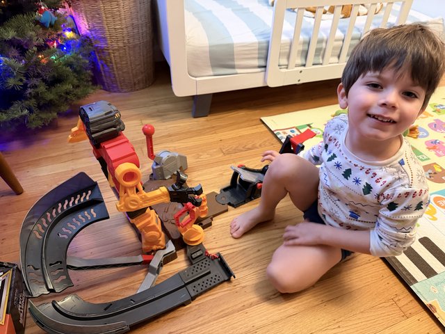 Happy Child Playing with Construction Toy Set at Christmas
