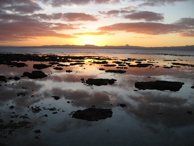 Serene Sunset Scene at the Rocky Beach