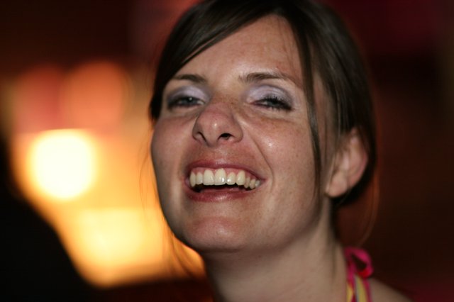 Joyful Woman Laughing in Warm Ambient Light