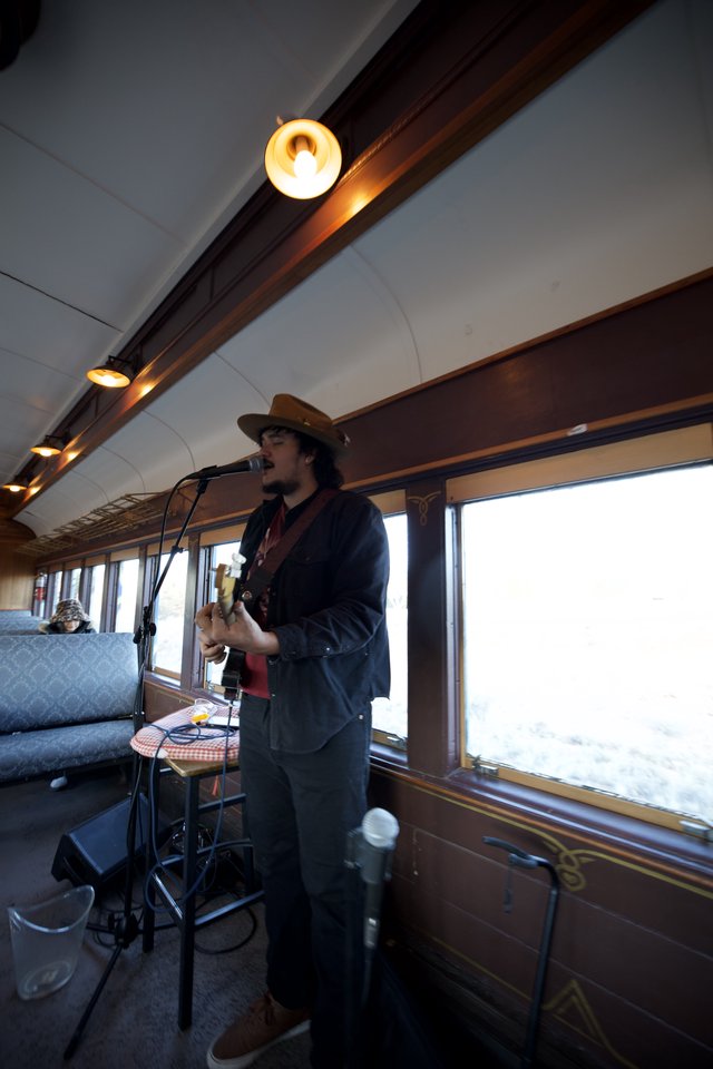 Musician Performing on Vintage Train Car