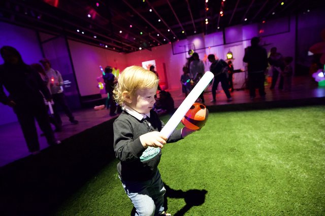 Child with Light Saber at Baby Rave Event