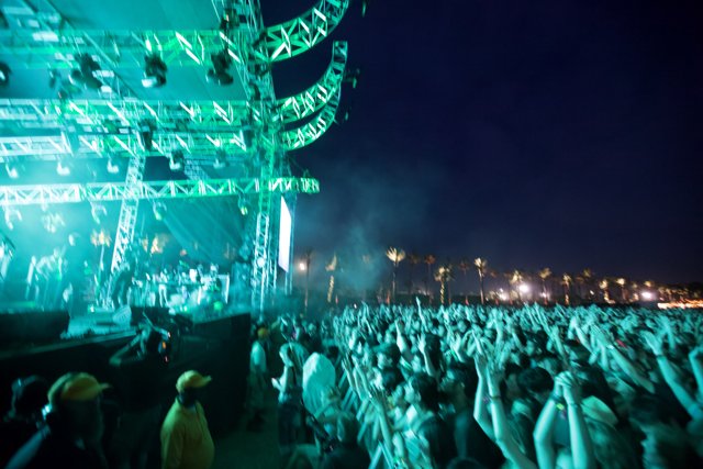 Green Lights Illuminate Rock Concert Crowd
