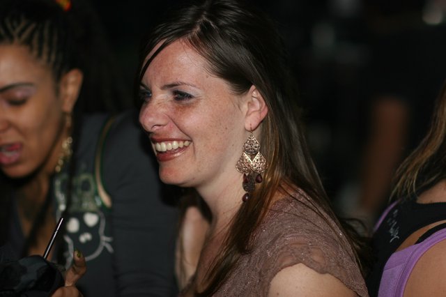 Woman Laughing Joyfully at Nighttime Social Event