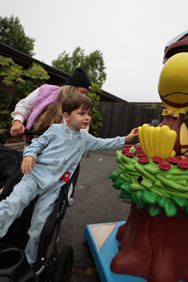 Curious Boy Reaches Out to Touch Colorful Statue