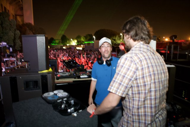 Two Men Grooving to the Beat at a Concert