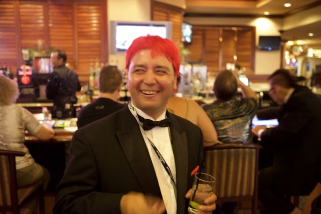 Red-haired man enjoys a drink at the bar