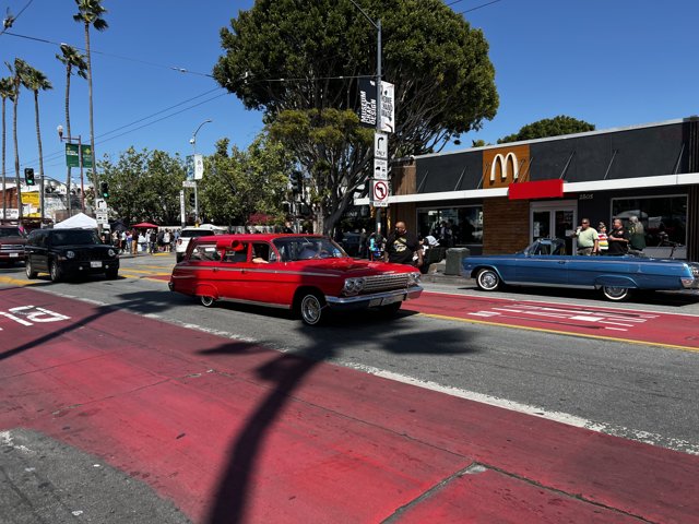Red Coupe Parked at Busy Intersection