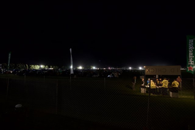 Nighttime Gathering by the Fence