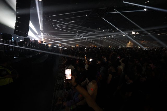 Massive Crowd Illuminated by Laser Light Show