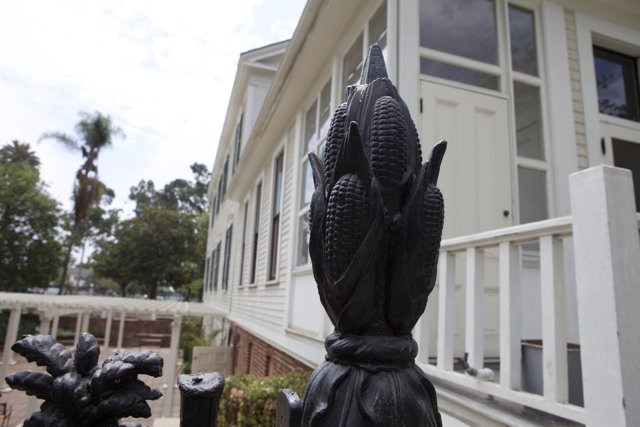 Corn Statue Adorns Fence in Front of Historic Monastery House