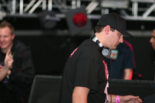 Black-Shirted DJ Amongst Enthusiastic Crowd