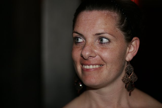 Freckled Woman Smiling Candidly at Evening Event