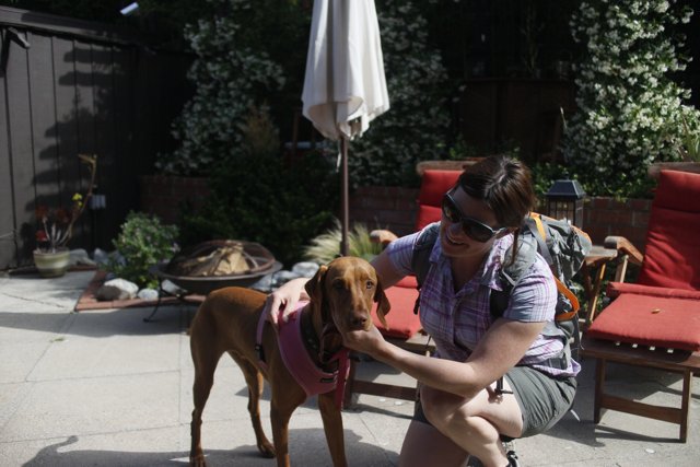 Woman Enjoying Sunny Day with Pet Dog