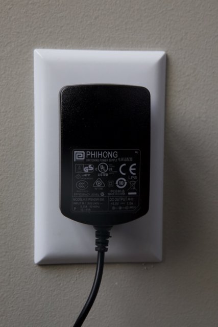 Power Plug Connected to Wall Outlet