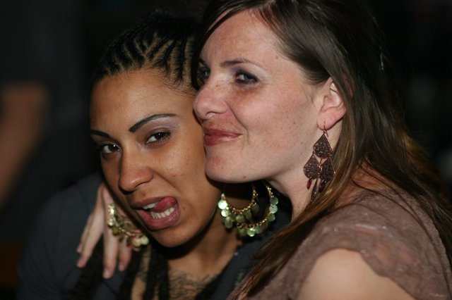 Two Friends Sharing a Playful Moment at Night Event