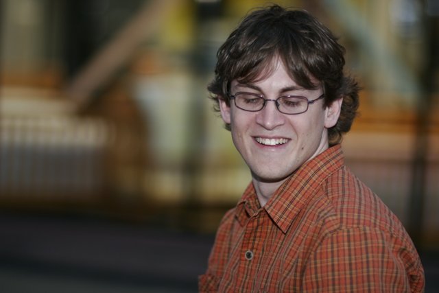 Happy Man in Plaid Shirt with Glasses