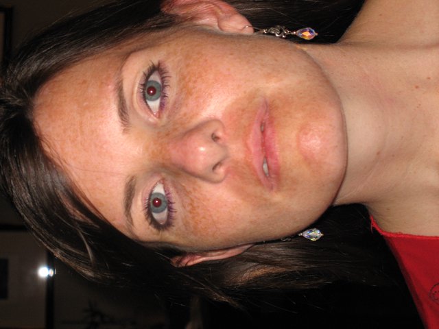 Freckled Woman in Red with Crystal Earrings
