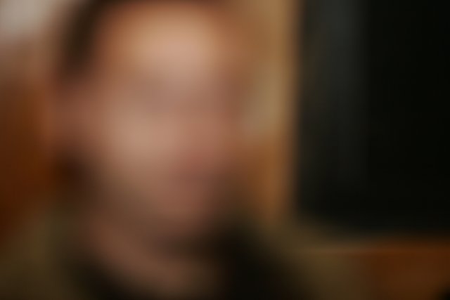 Blurry Portrait of a Person in a Dark Room