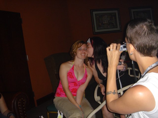 Friends Sharing a Playful Kiss at DEF CON Party
