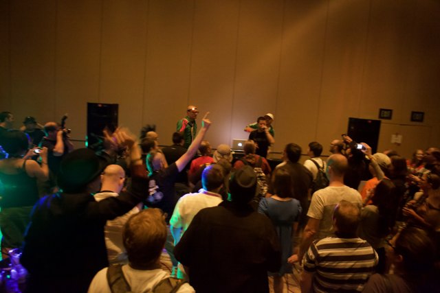 Crowd at Defcon Convention with Hat-Wearing Man
