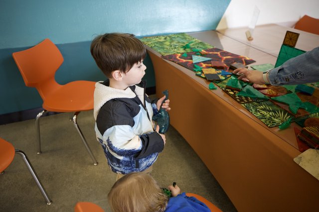 Young Boy Engaged in Interactive Museum Learning Activity