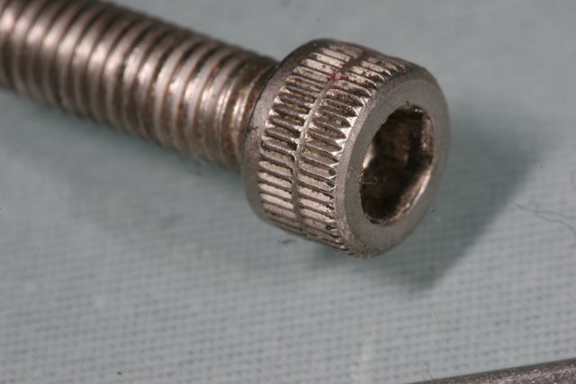 Macro View of a Screw, Nut, and Screwdriver
