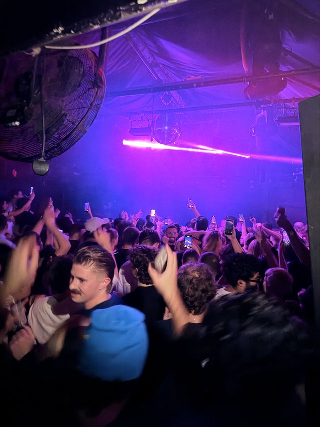 Purple-Lit Nightclub Crowd at London Venue