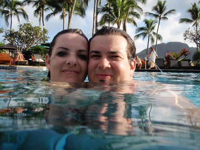 Couple Posing at Water Level in Tropical Pool