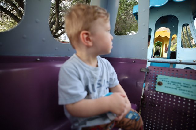Young Boy Enjoying a Ride at Fantasyland Theme Park