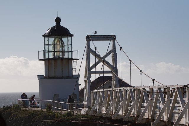 A Serene View of the White Bridge and Lighthouse