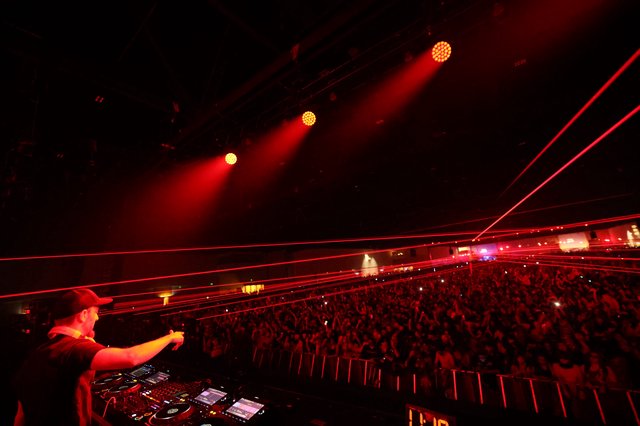 DJ Ignites Massive Crowd with Red Laser Light Show