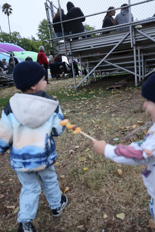 Children Playing with Skewered Snacks at Balloon Festival