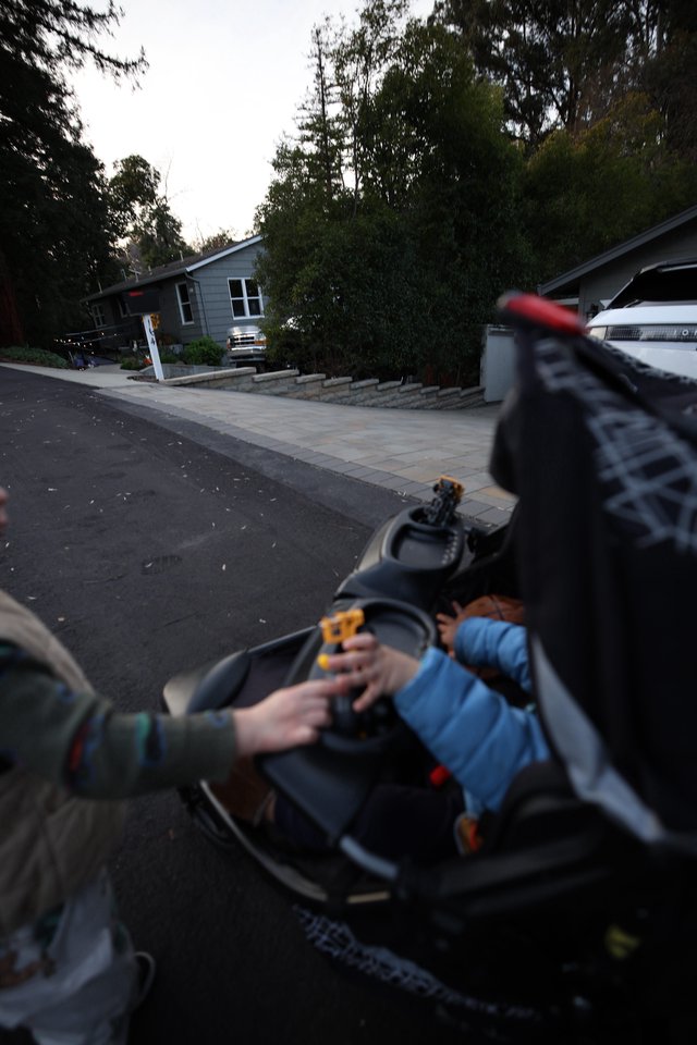 Evening Stroll with Baby in Residential Driveway